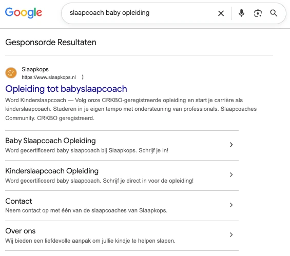 Google results for “slaapcoach baby opleiding”: Slaapkops as the top ad, with sitelinks